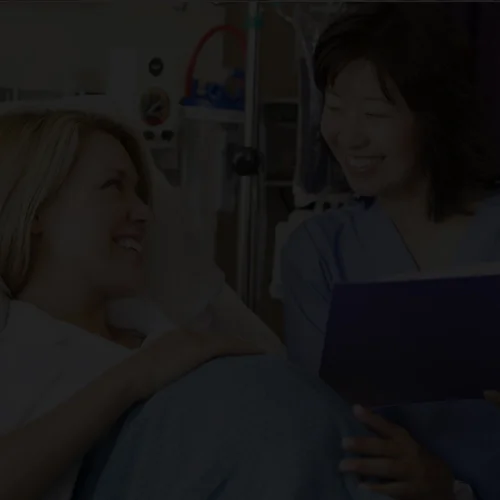 Medical assistant supporting patient recovering from surgery